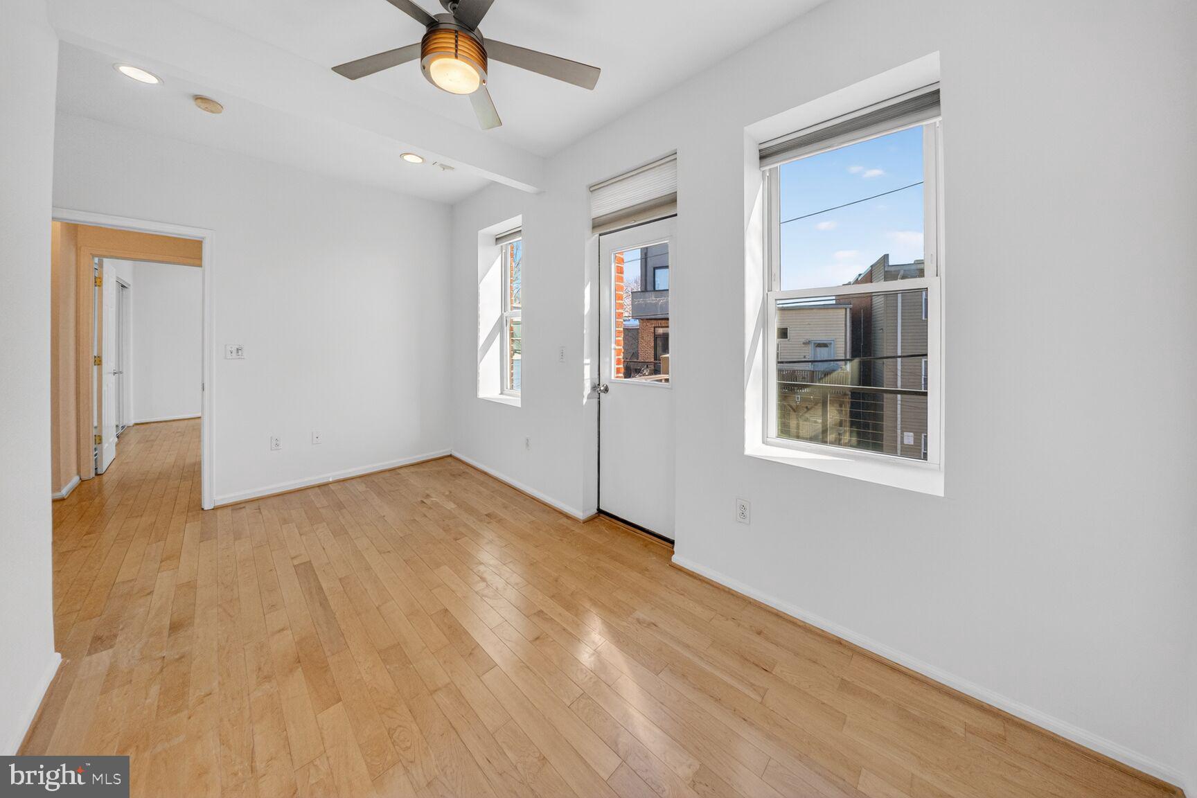 424 Q Street Northwest, Unit H Washington, DC 20001 - Photo 12 of 16 a view of empty room with wooden floor and ceiling fan