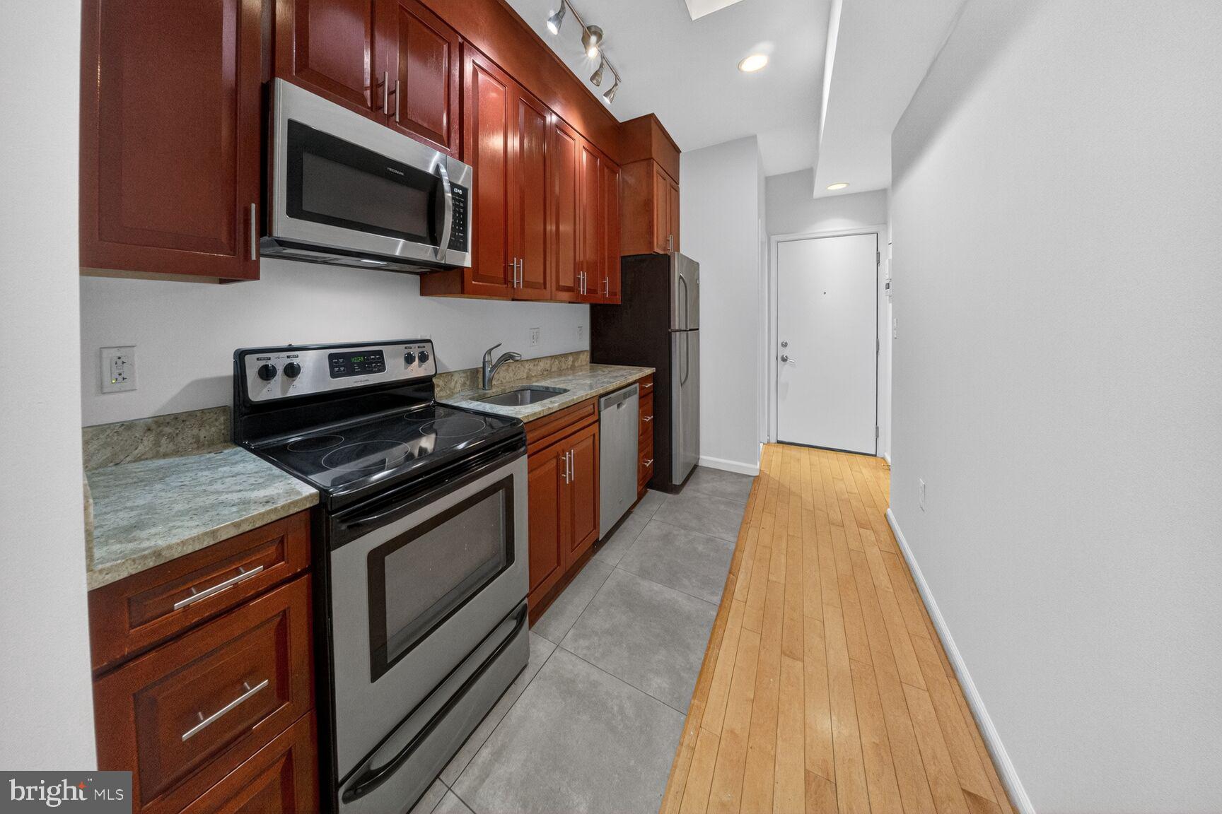 424 Q Street Northwest, Unit H Washington, DC 20001 - Photo 5 of 16 a kitchen with stainless steel appliances granite countertop a stove and a microwave