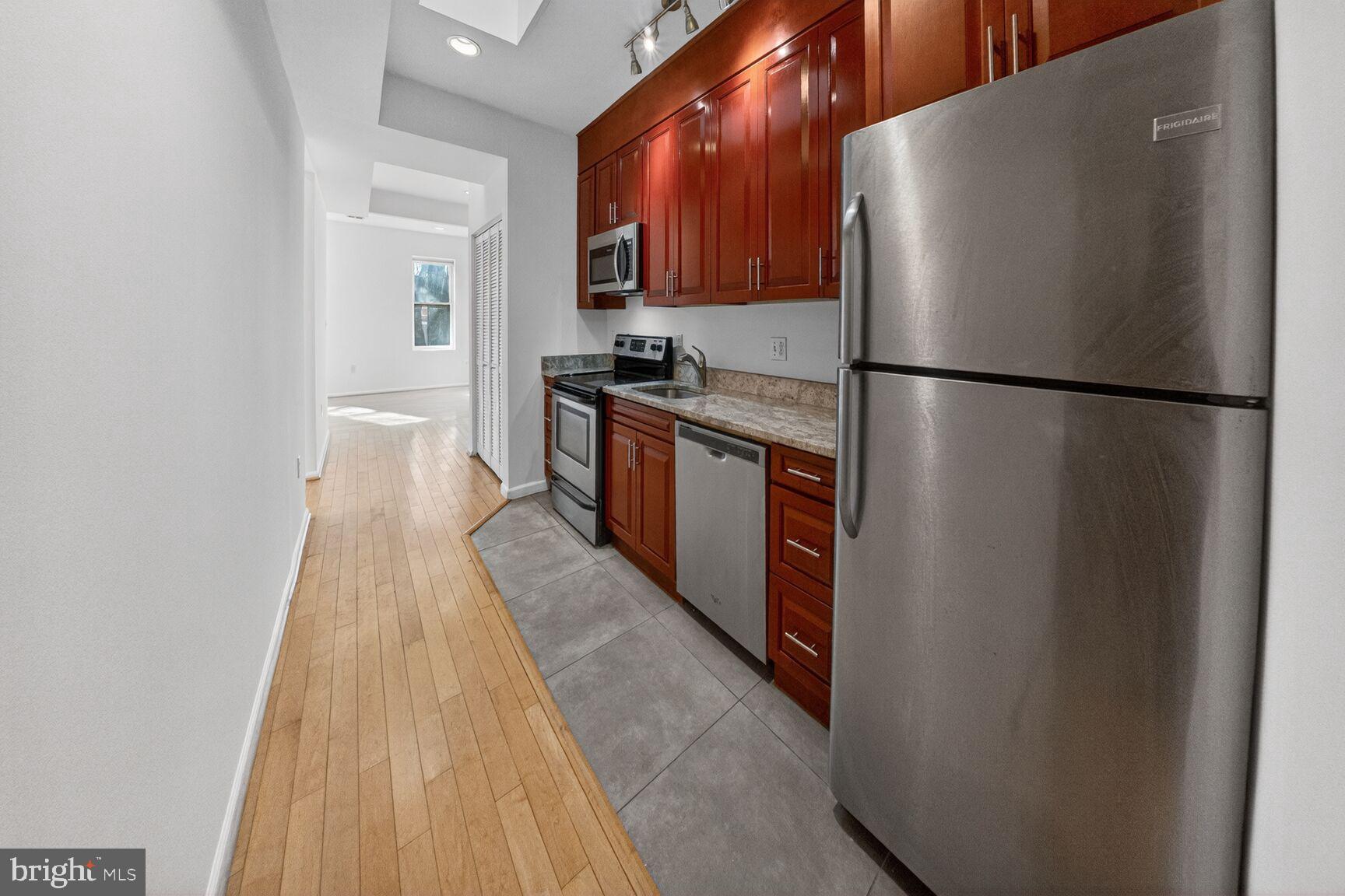 424 Q Street Northwest, Unit H Washington, DC 20001 - Photo 6 of 16 a kitchen with stainless steel appliances granite countertop a refrigerator a stove and a sink