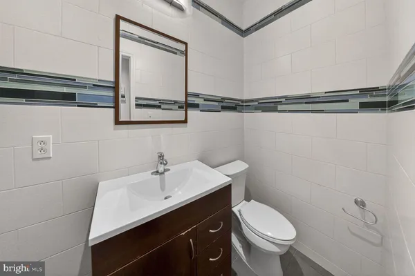 a bathroom with a sink toilet and vanity