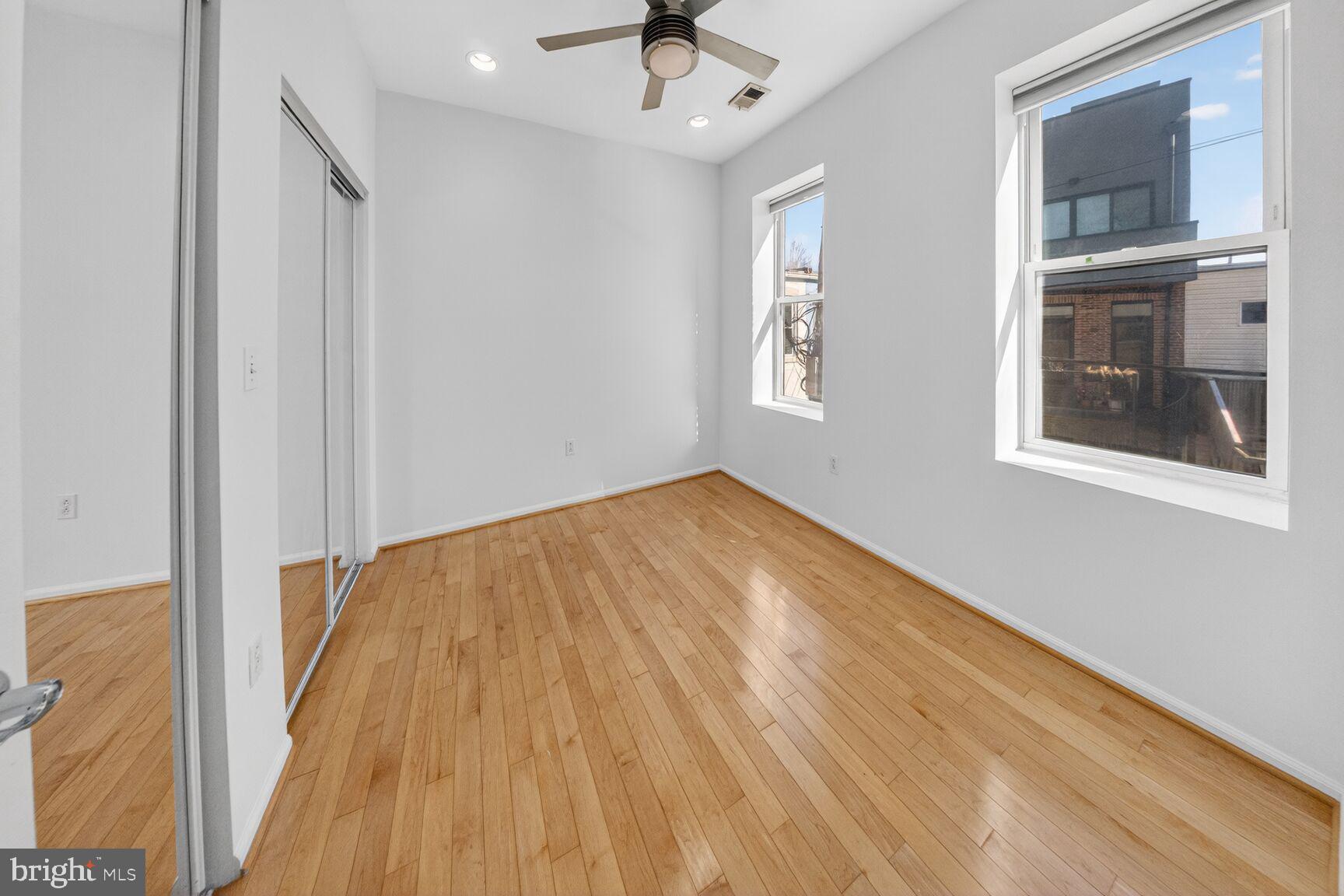 424 Q Street Northwest, Unit H Washington, DC 20001 - Photo 9 of 16 a view of empty room with wooden floor and fan