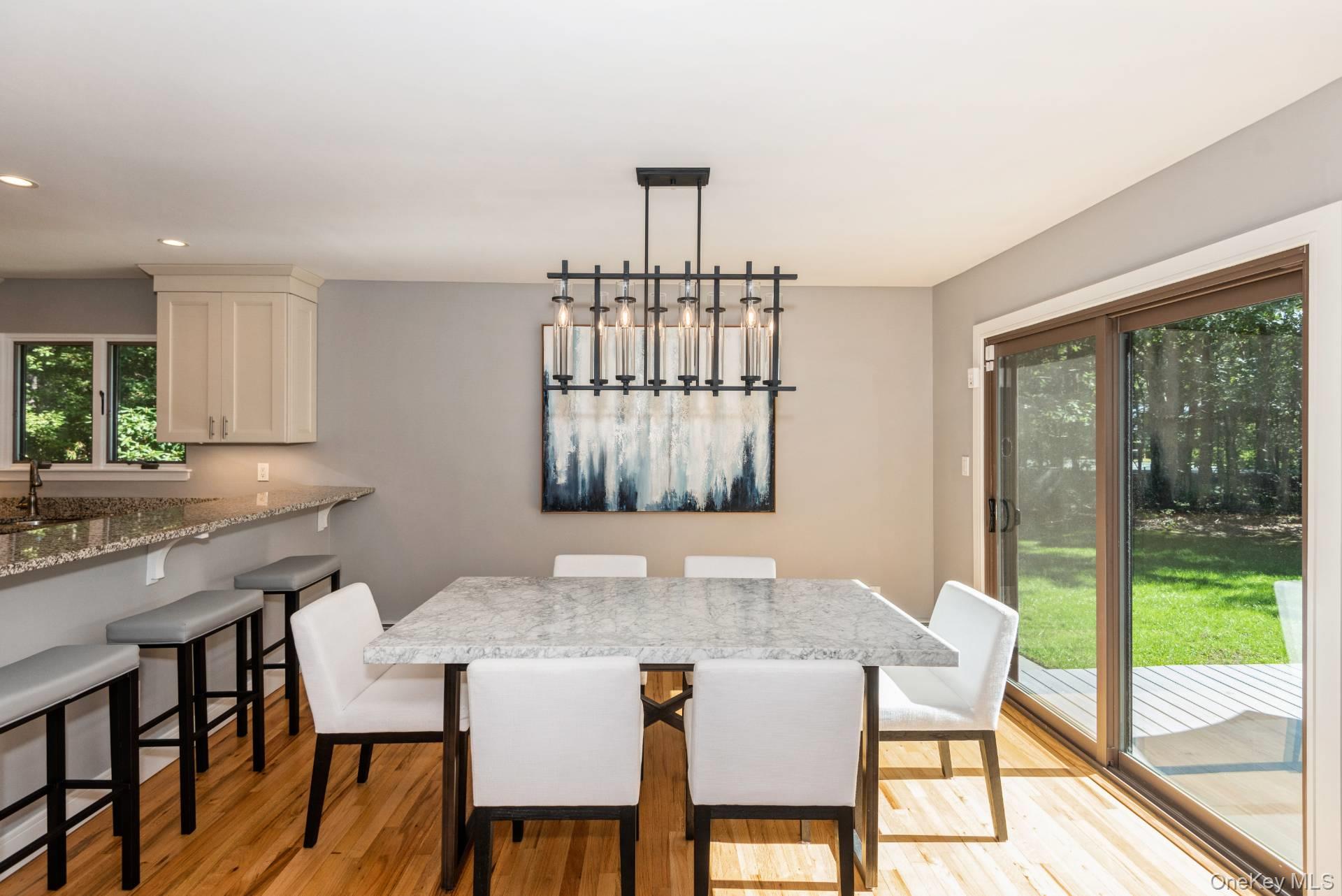 1 Deer Path Quogue, NY 11959 - Photo 15 of 38 a view of a dining room with furniture window and outside view