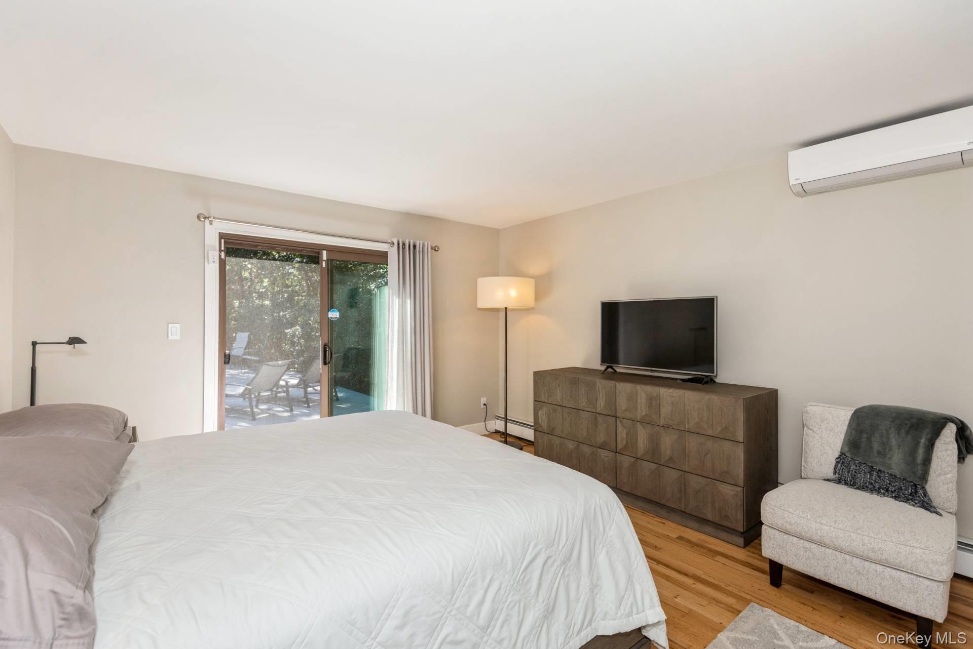 1 Deer Path Quogue, NY 11959 - Photo 16 of 38 a bedroom with a bed and a television