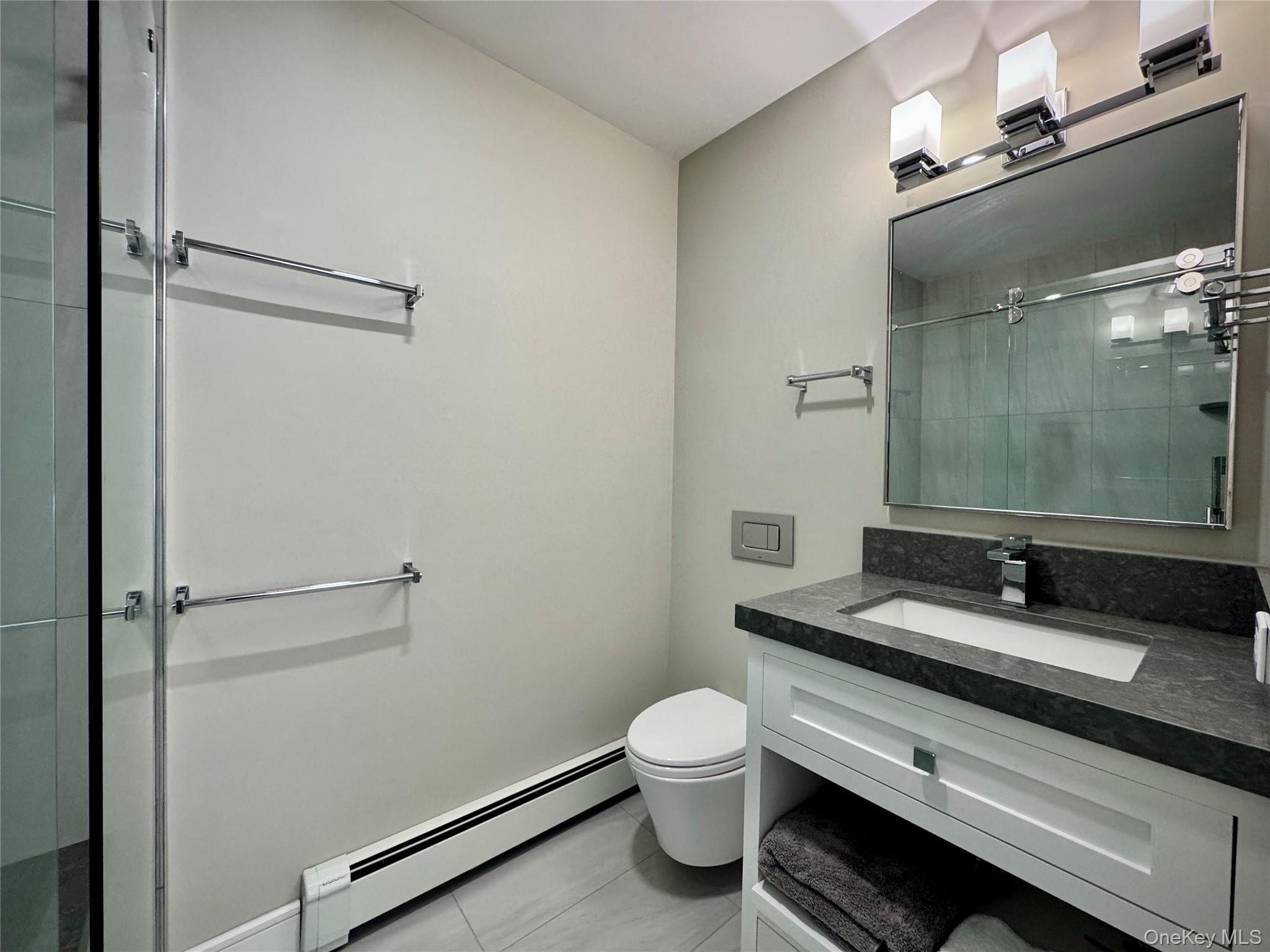 1 Deer Path Quogue, NY 11959 - Photo 19 of 38 a bathroom with a granite countertop sink toilet and mirror