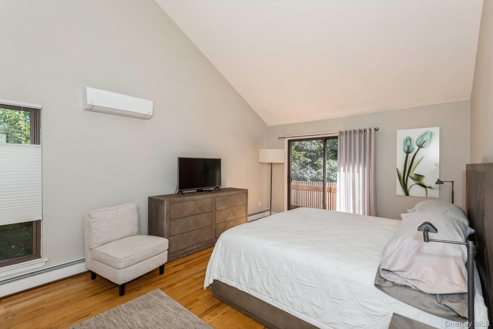 1 Deer Path Quogue, NY 11959 - Photo 23 of 38 a bedroom with a bed and a couch