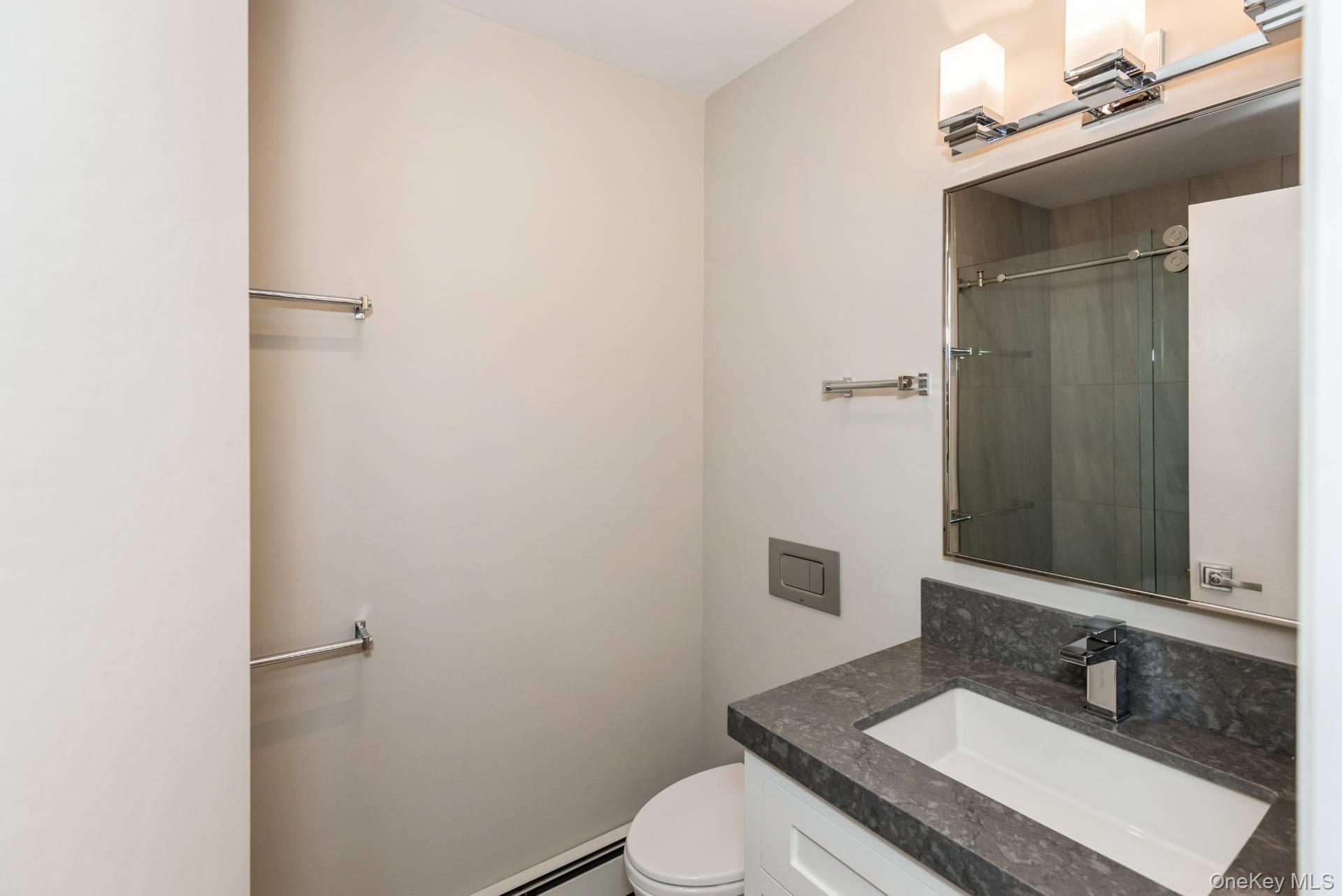 1 Deer Path Quogue, NY 11959 - Photo 30 of 38 a bathroom with a sink and a mirror