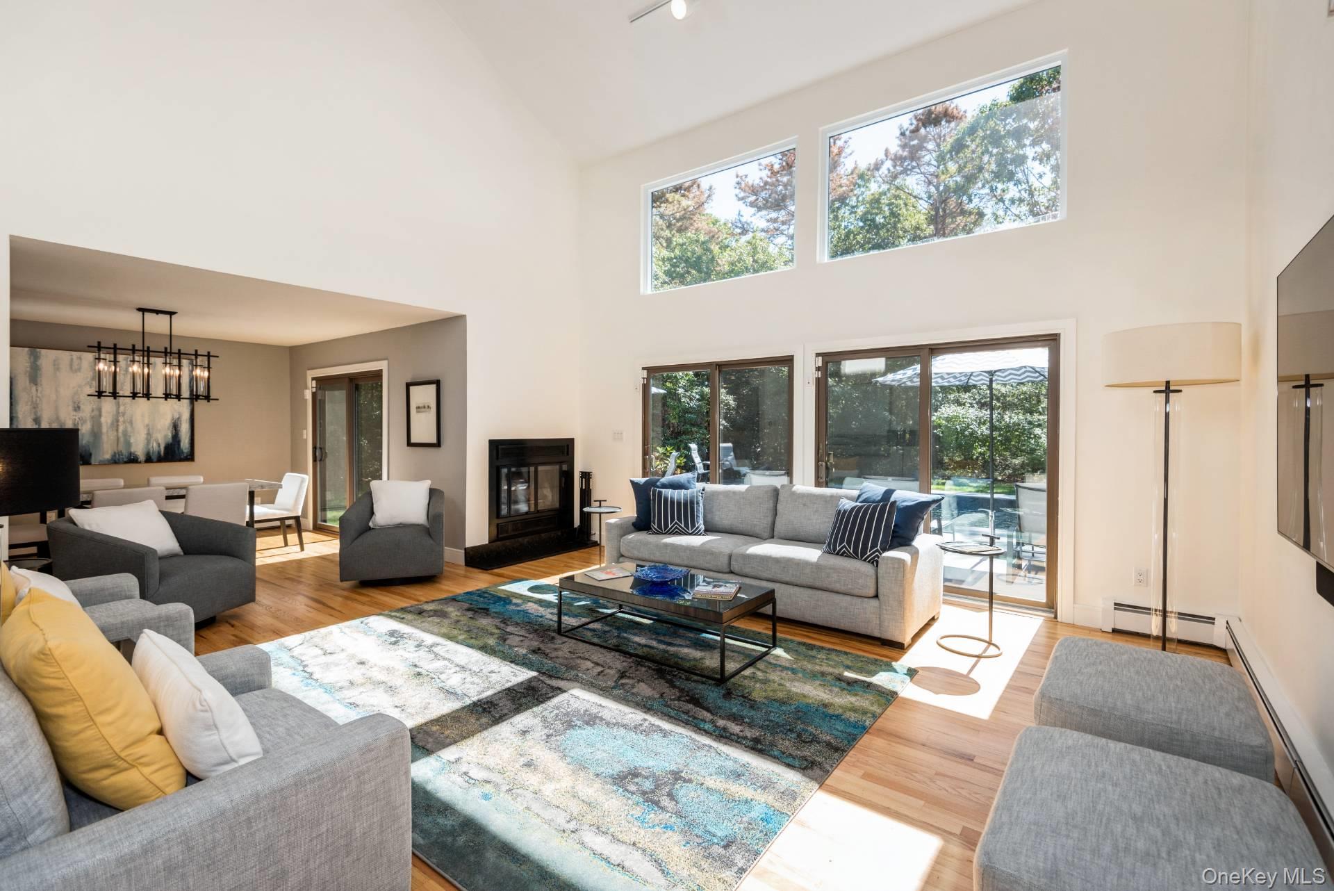 1 Deer Path Quogue, NY 11959 - Photo 3 of 38 a living room with furniture large window and a table