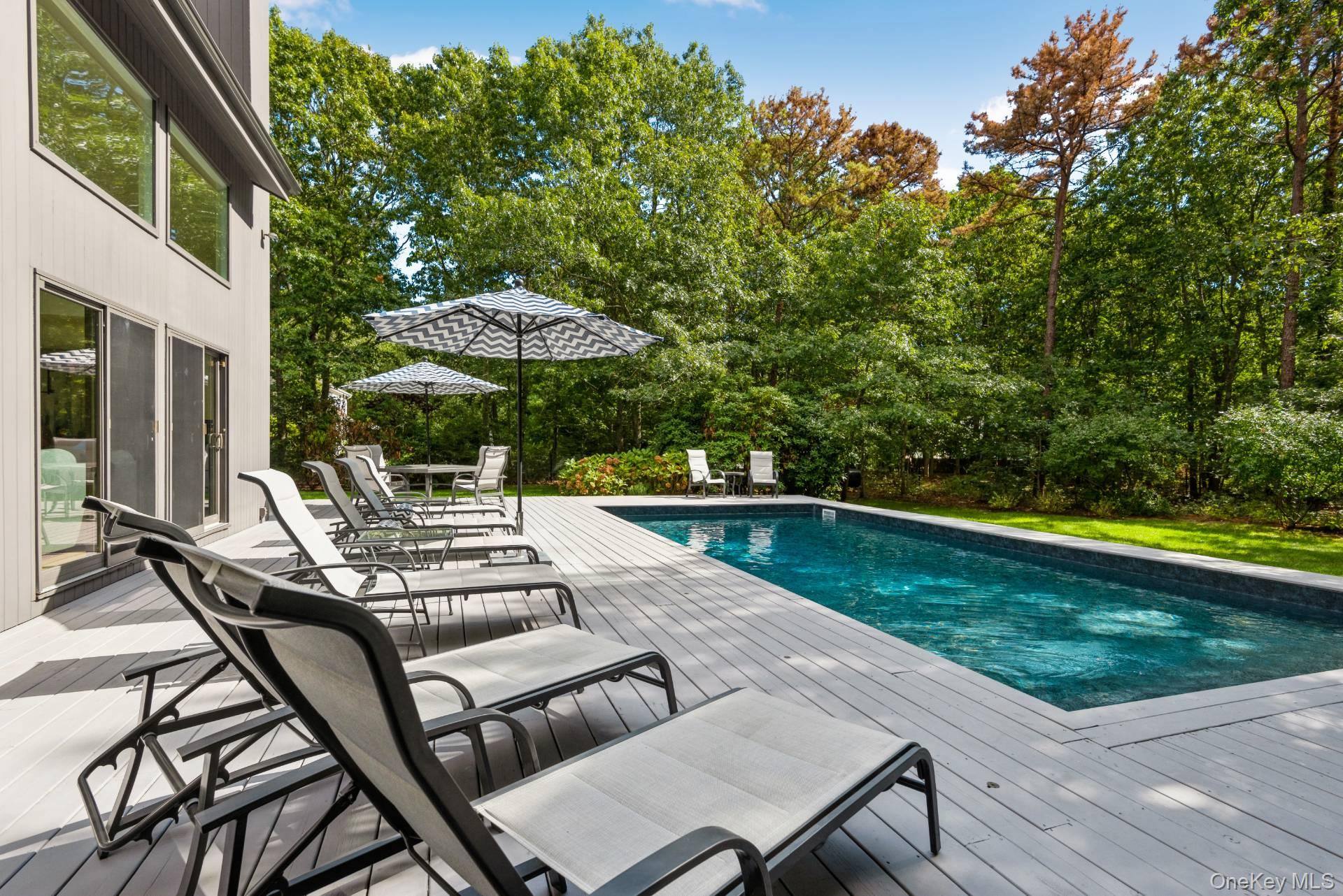 1 Deer Path Quogue, NY 11959 - Photo 35 of 38 a view of patio with swimming pool table and chairs