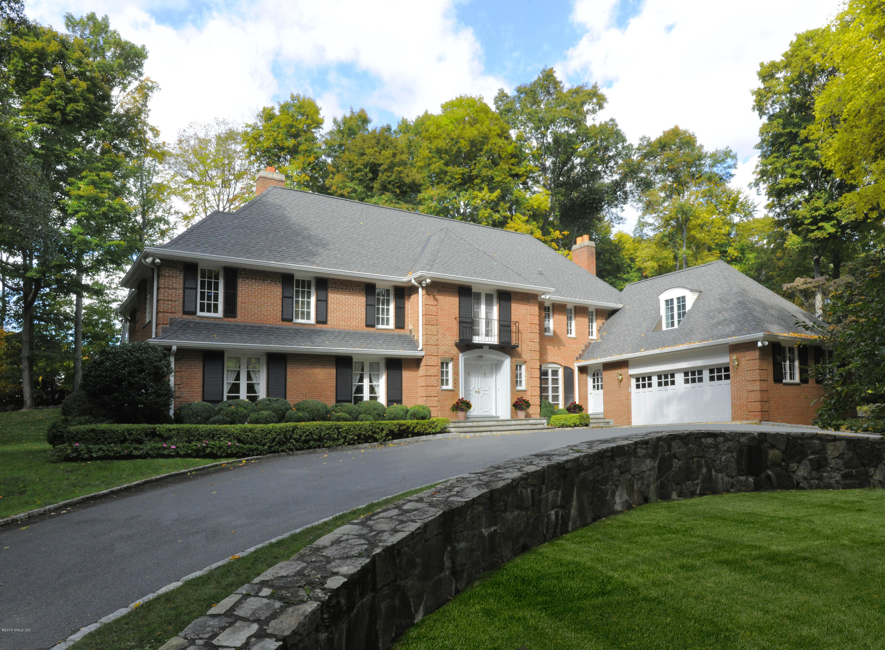95 Perkins Road Greenwich, CT 06830 - Photo 1 of 30 a front view of a house with a yard