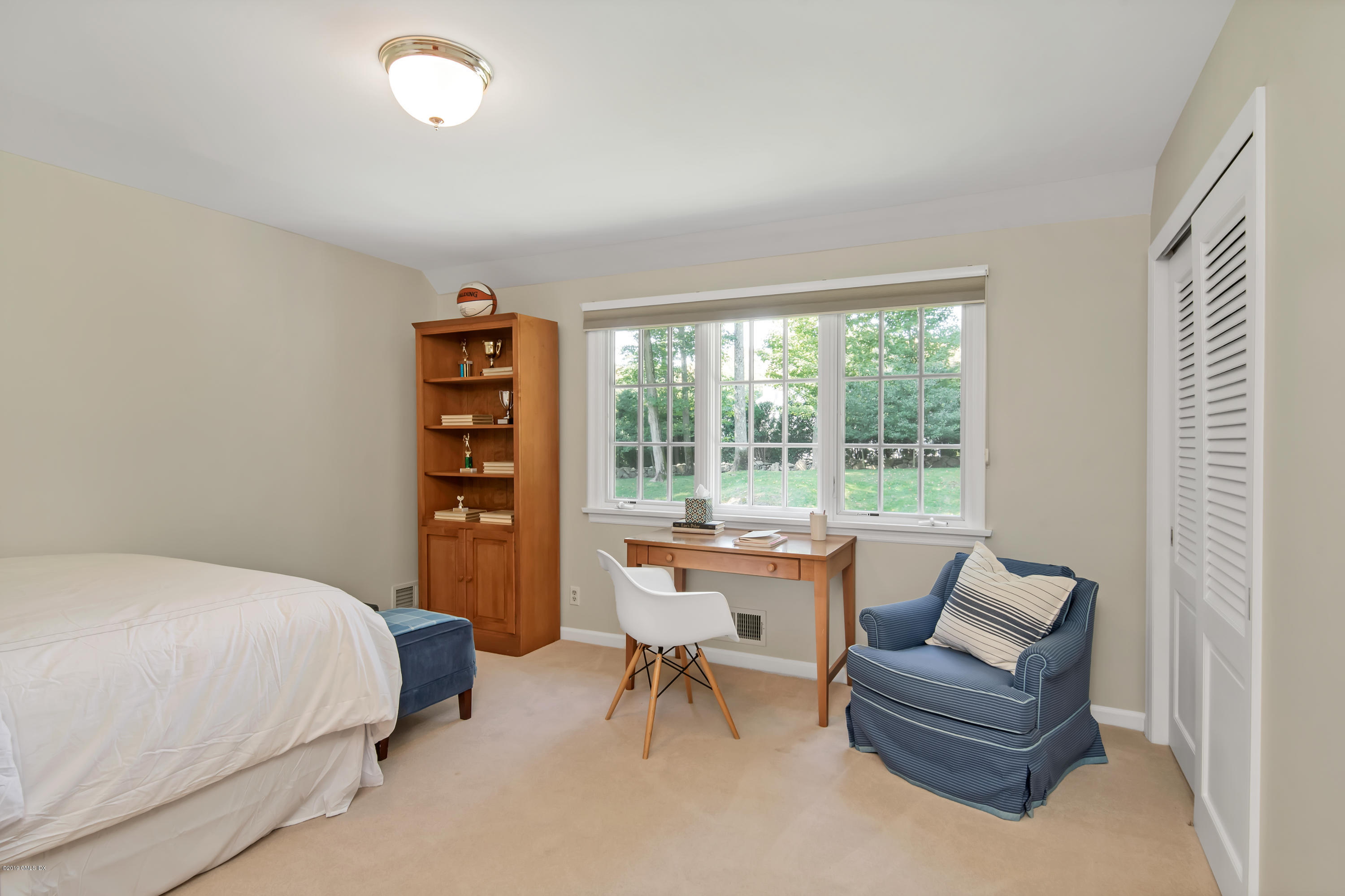 95 Perkins Road Greenwich, CT 06830 - Photo 16 of 30 a bedroom with a bed and a couch next to a window