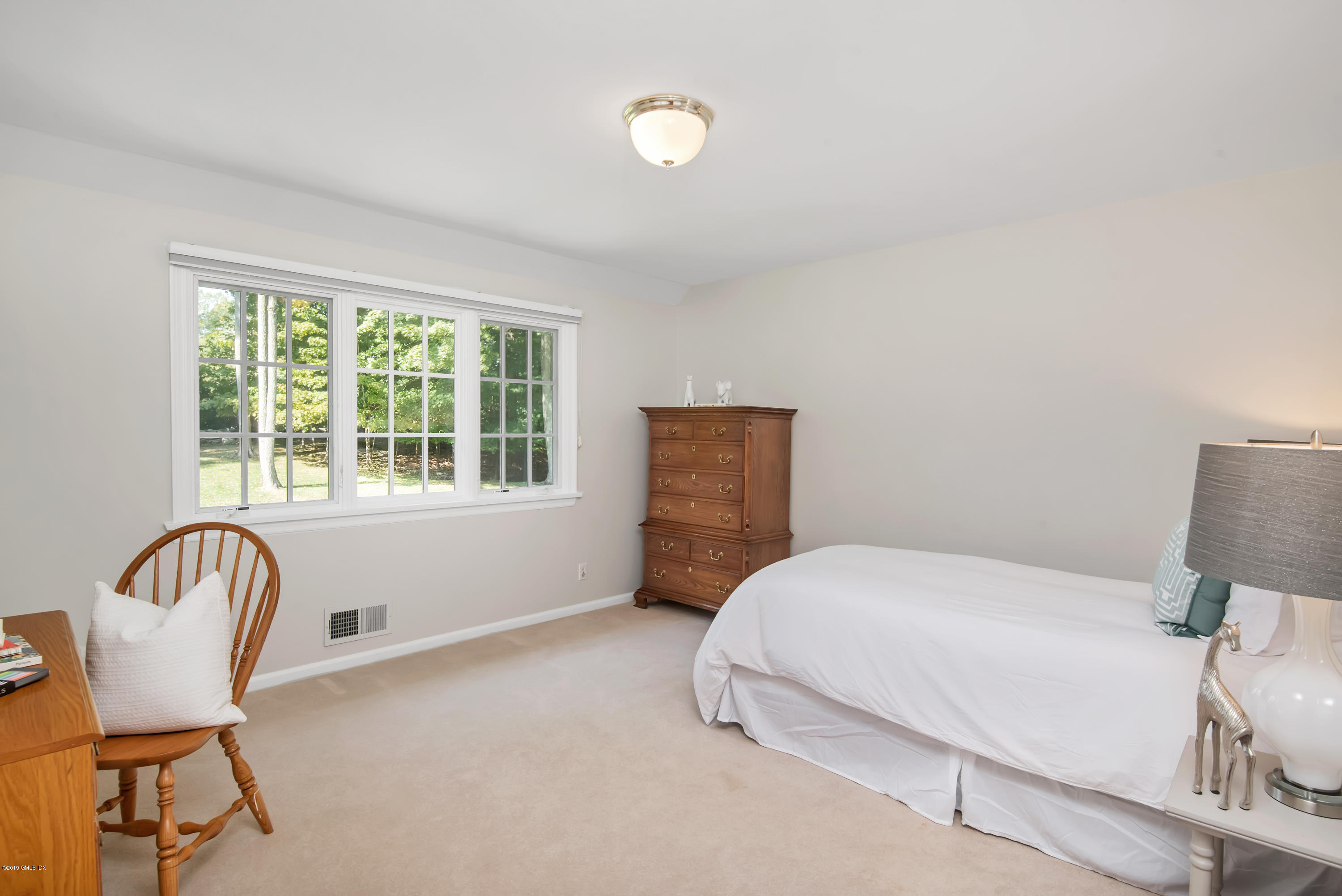 95 Perkins Road Greenwich, CT 06830 - Photo 17 of 30 a bedroom with a bed chair and window