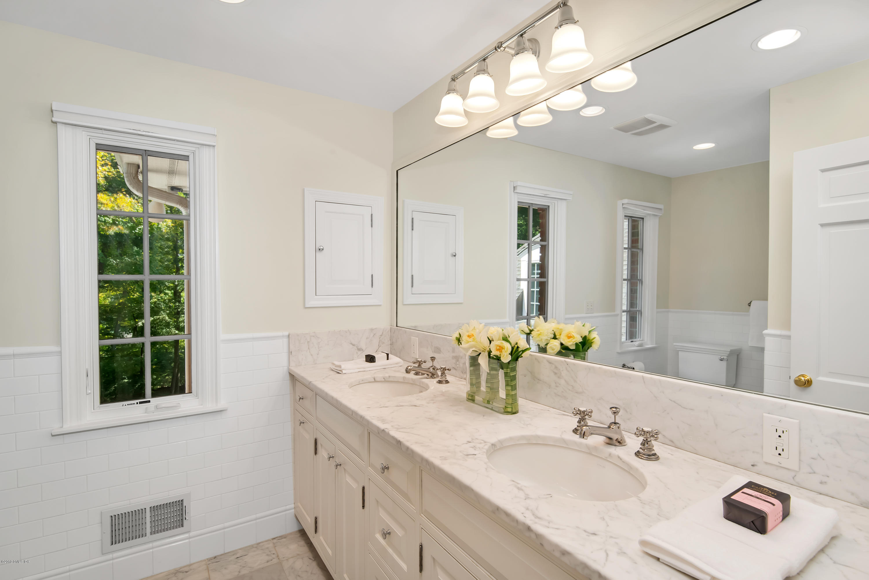 95 Perkins Road Greenwich, CT 06830 - Photo 18 of 30 a bathroom with double vanity and a mirror