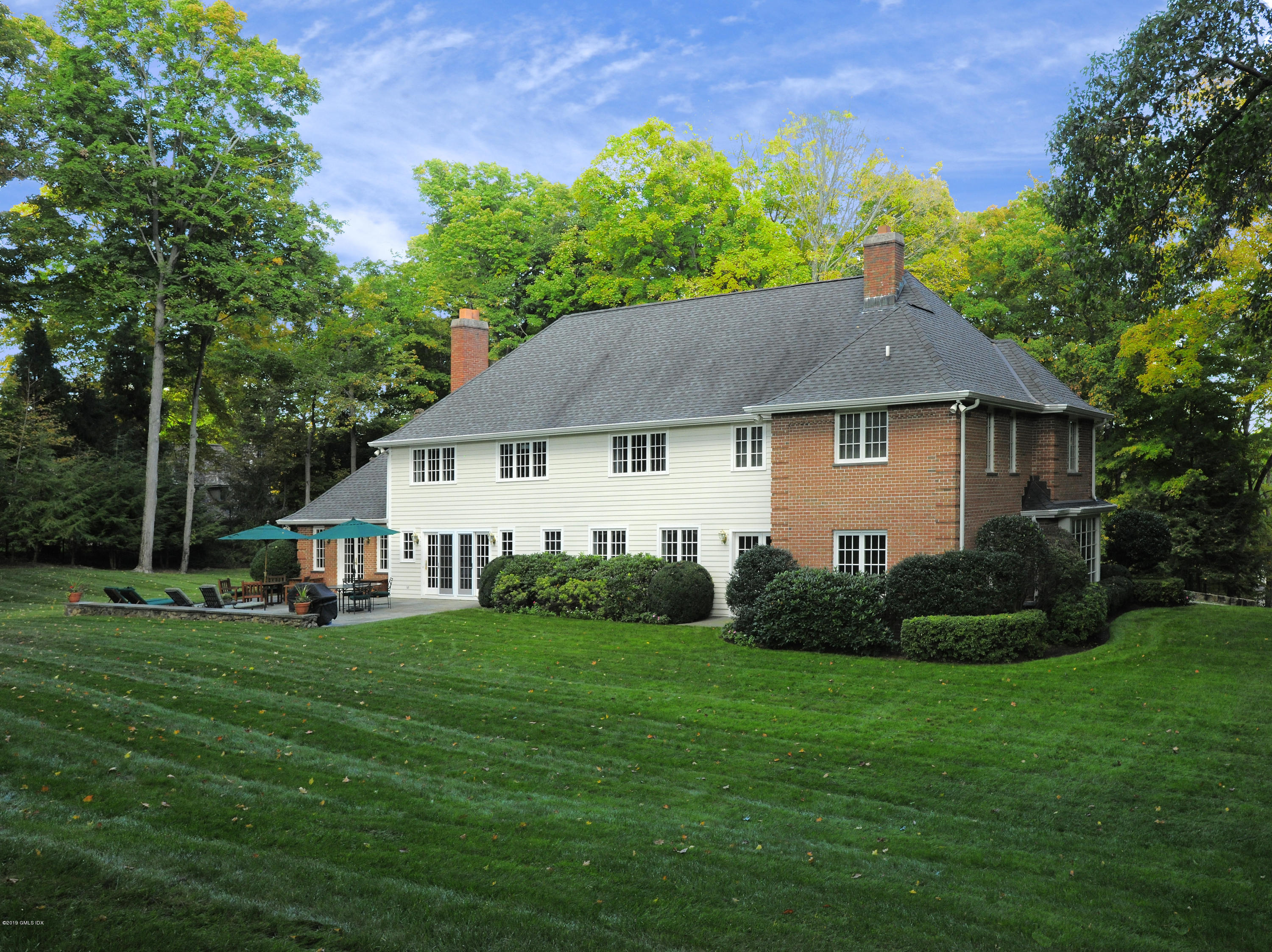 95 Perkins Road Greenwich, CT 06830 - Photo 23 of 30 a front view of a house with garden