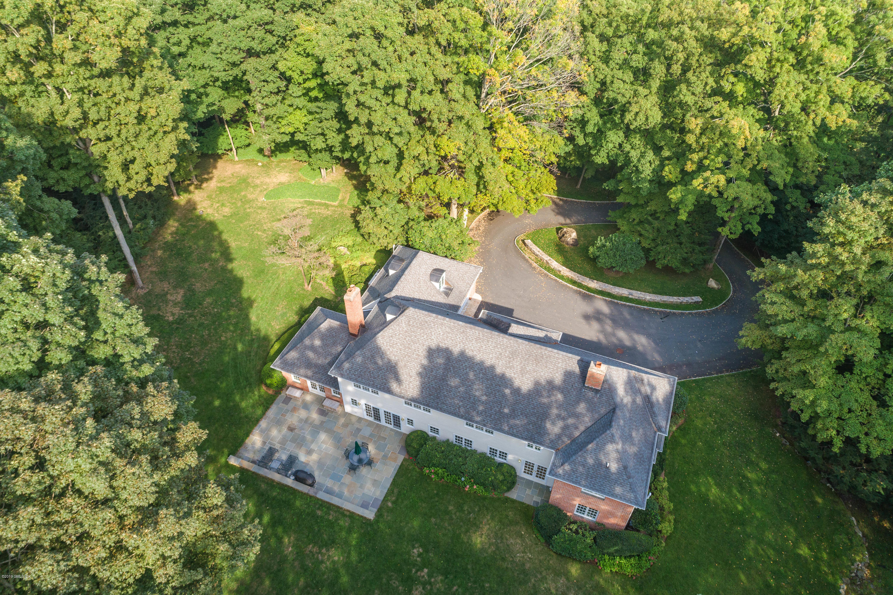 95 Perkins Road Greenwich, CT 06830 - Photo 25 of 30 an aerial view of a house with a yard basket ball court and outdoor seating