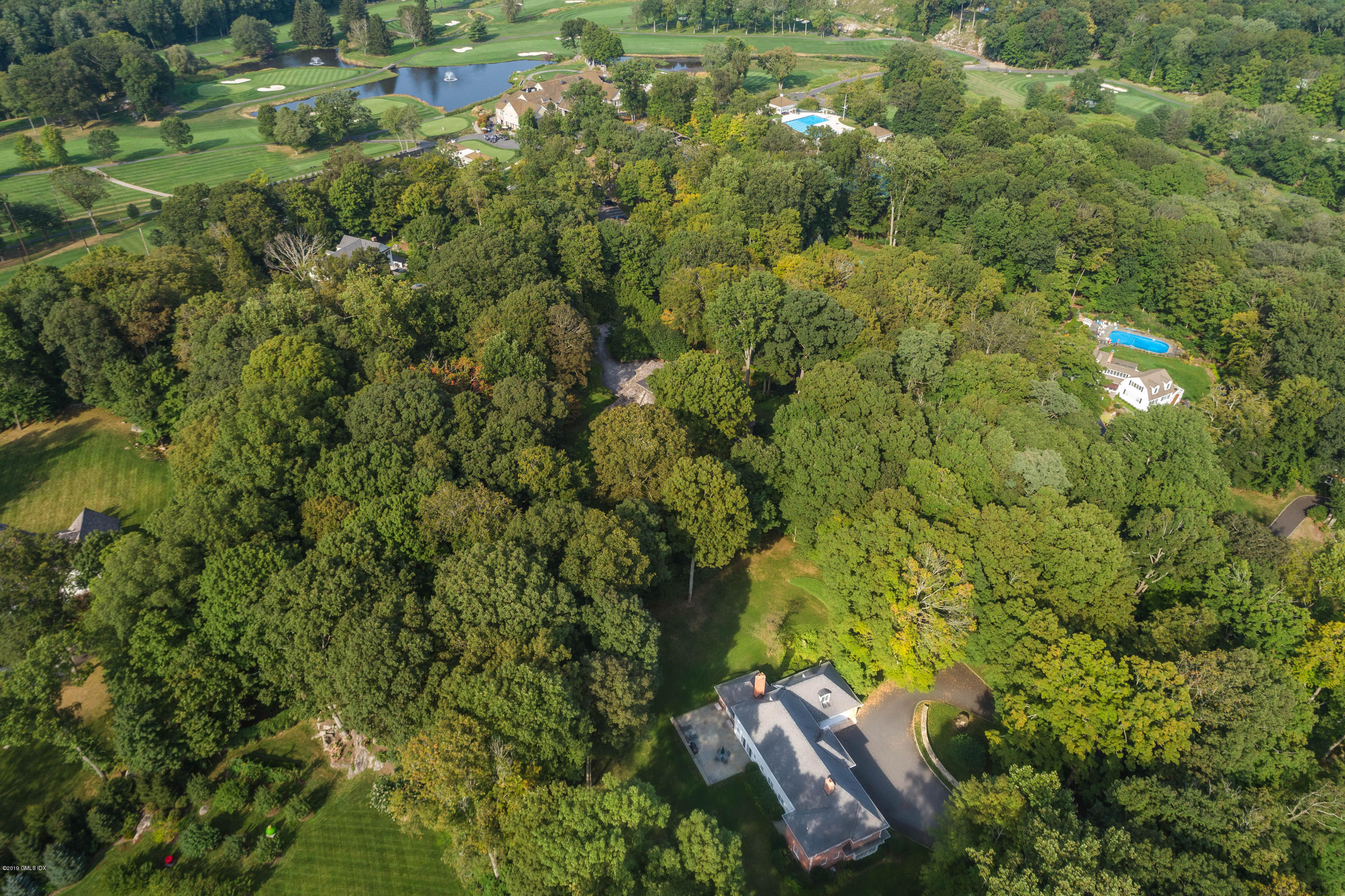 95 Perkins Road Greenwich, CT 06830 - Photo 26 of 30 an aerial view of residential house with outdoor space and trees all around