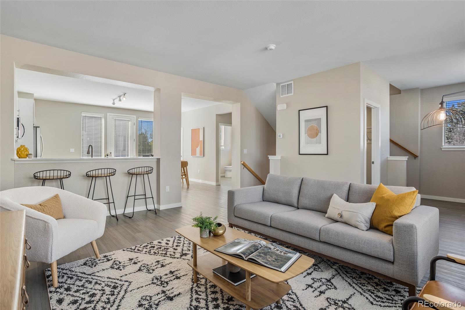 1850 South Quebec Way, Unit 101 Denver, CO 80231 - Photo 1 of 1 a living room with furniture and wooden floor