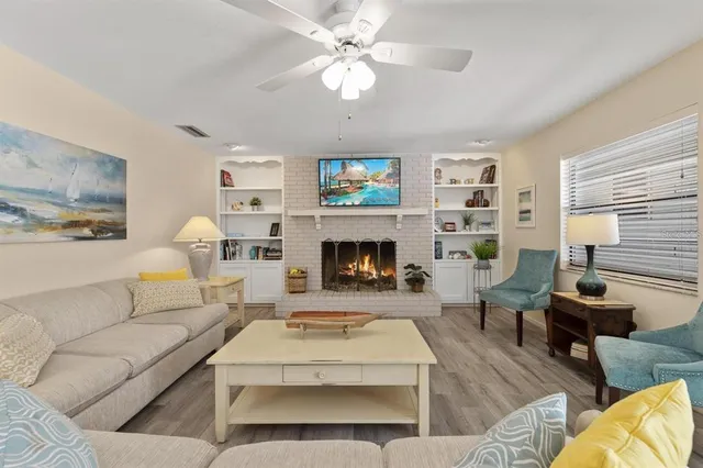 a living room with furniture a fireplace and a chandelier
