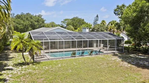 a house with swimming pool in front of it