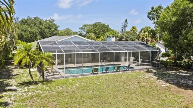 a house with swimming pool in front of it