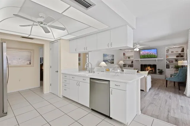 a kitchen with stainless steel appliances kitchen island granite countertop a sink and cabinets