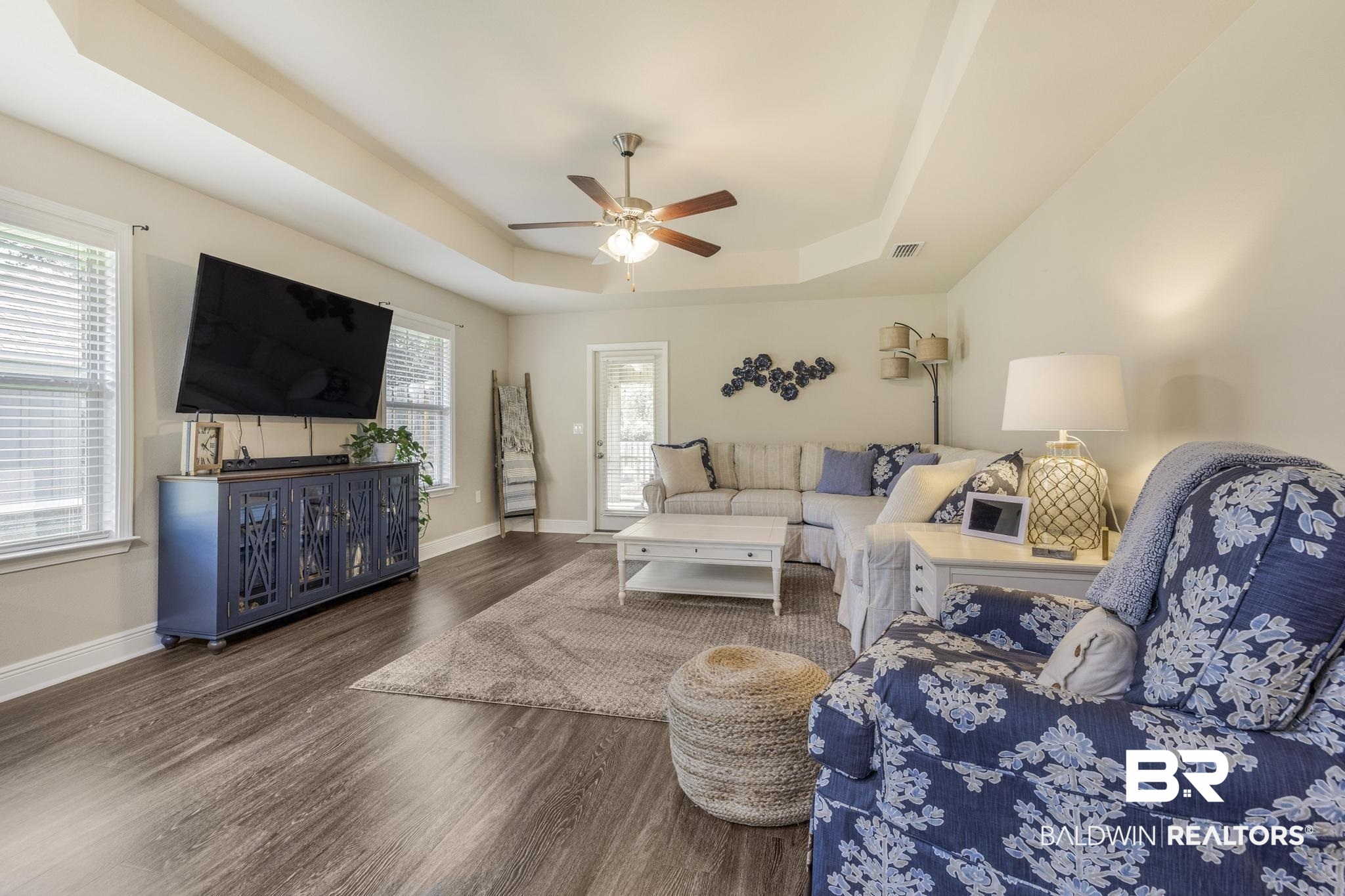 22043 Garland Loop Silverhill, AL 36576 - Photo 14 of 41 Living room featuring a raised ceiling, ceiling fan, and dark wood finished floors