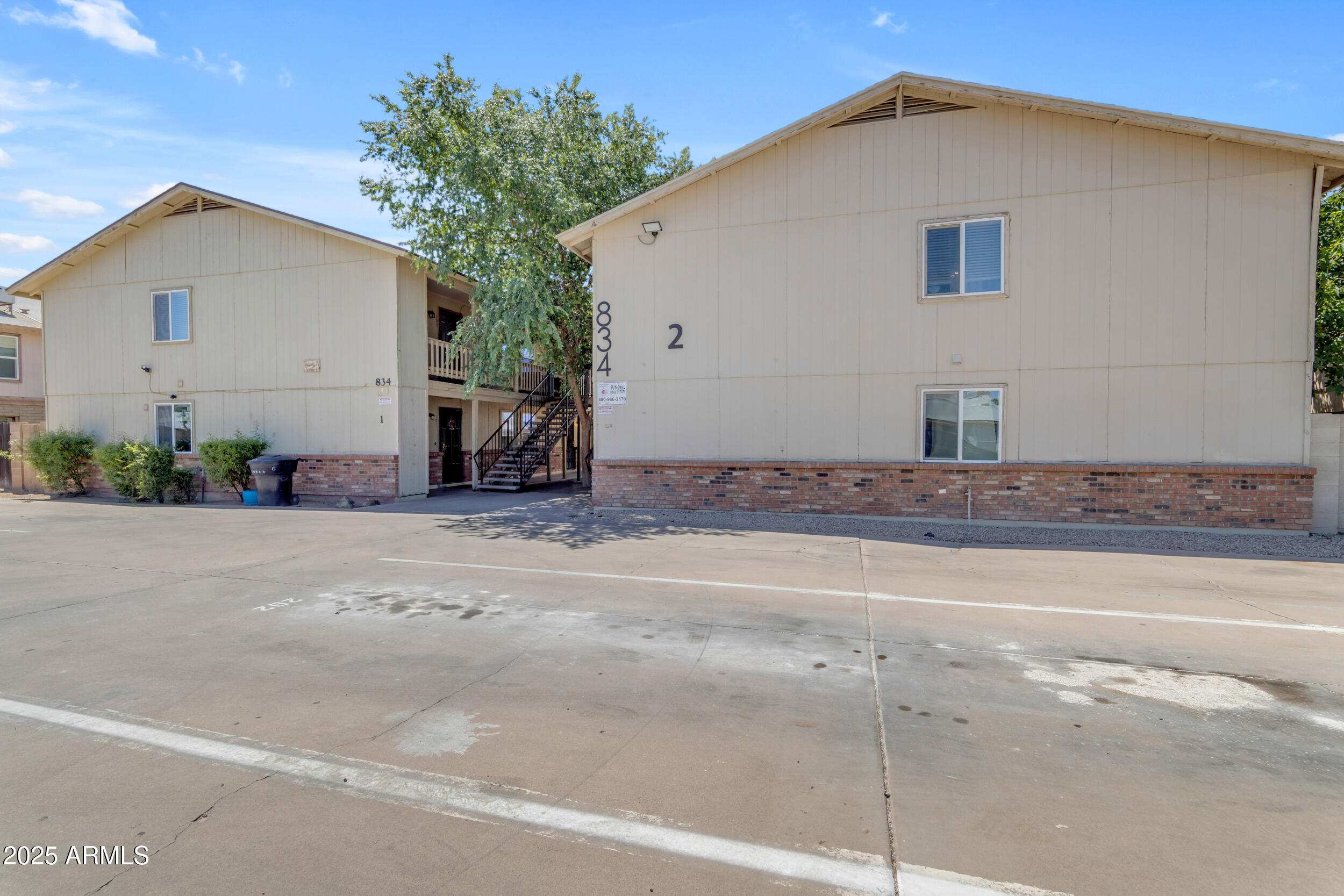 834 North Cherry, Unit 102 Mesa, AZ 85201 - Photo 1 of 24 a white house with a tree in front of it
