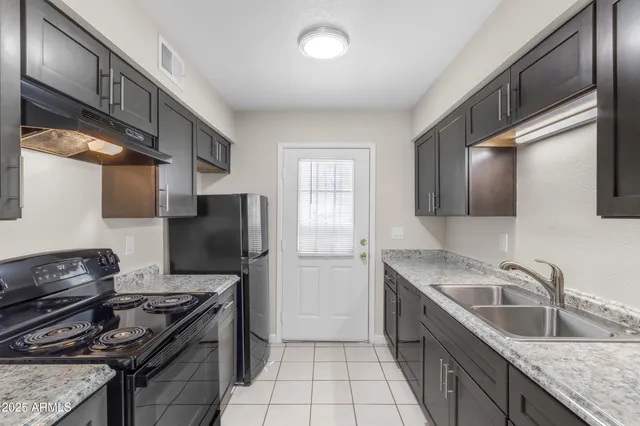 a kitchen with a sink and cabinets