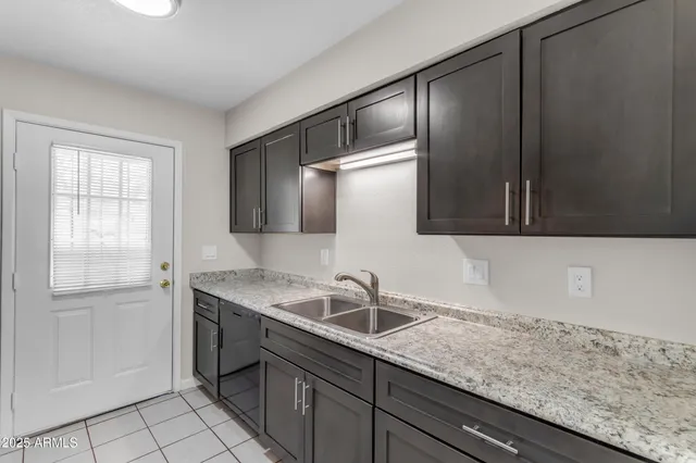 a kitchen with stainless steel appliances granite countertop a stove refrigerator and microwave