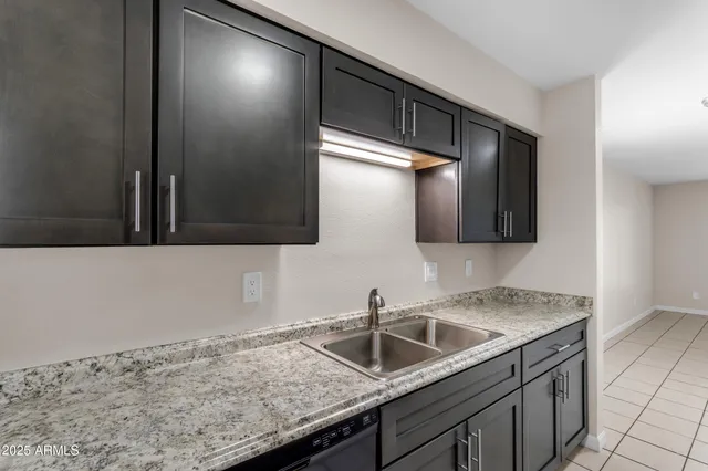 a kitchen with granite countertop stainless steel appliances and cabinets