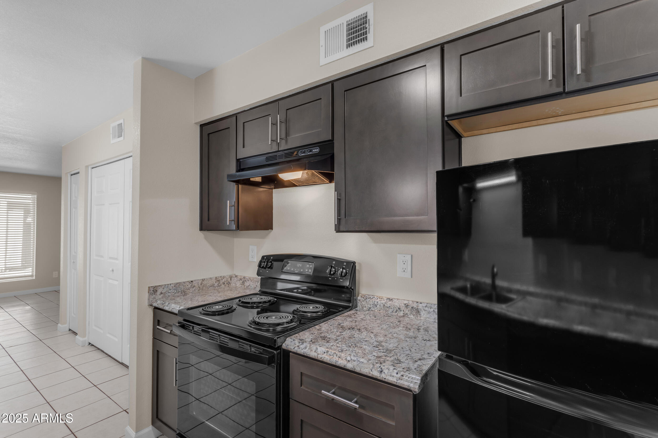 834 North Cherry, Unit 102 Mesa, AZ 85201 - Photo 16 of 24 a kitchen with granite countertop stainless steel appliances and cabinets