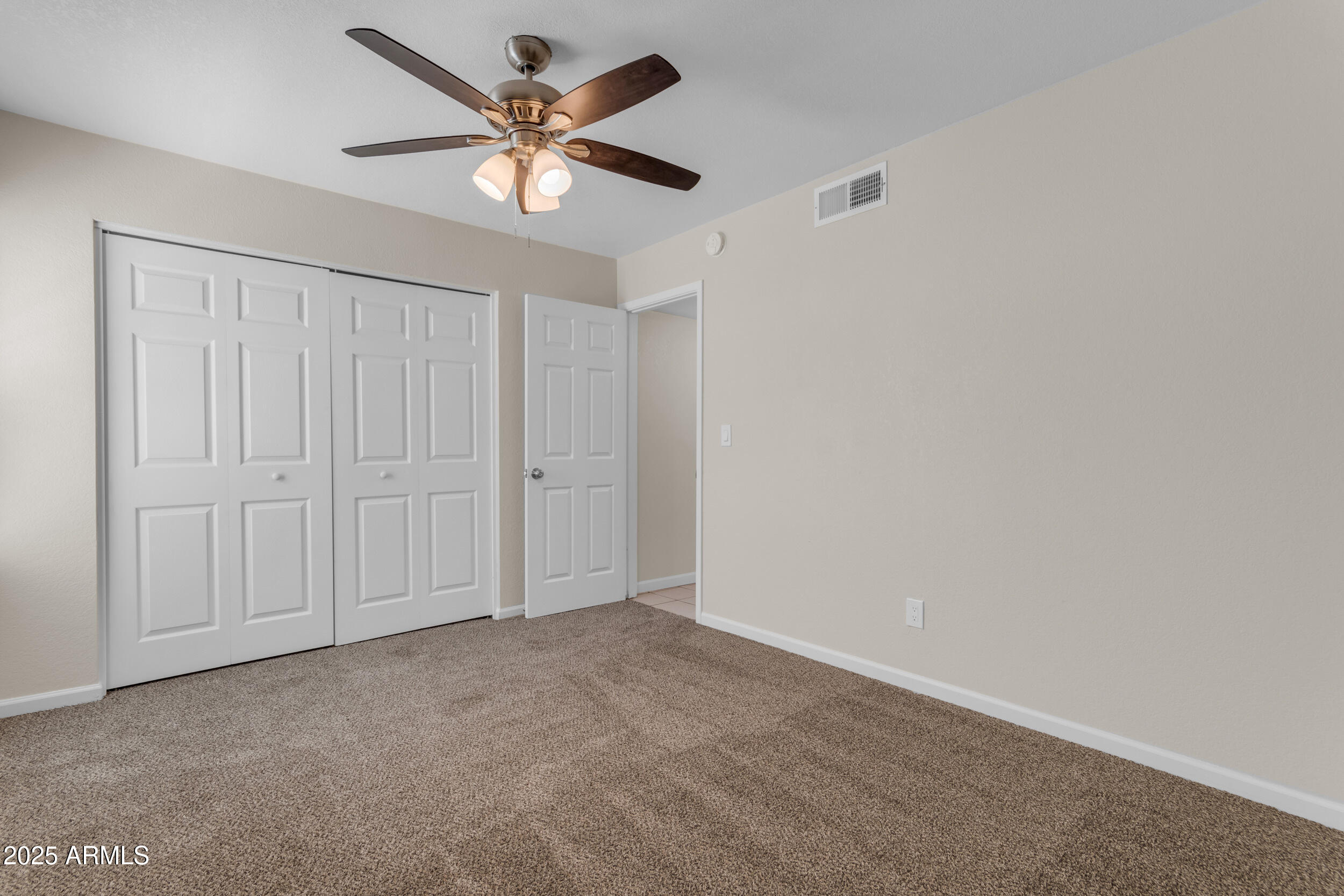 834 North Cherry, Unit 102 Mesa, AZ 85201 - Photo 17 of 24 an empty room with a ceiling fan and a window