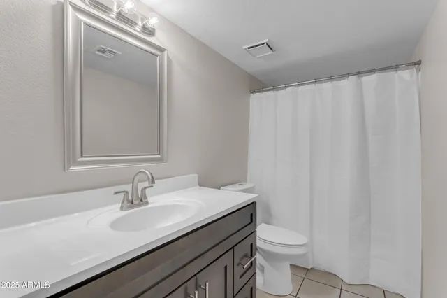 an empty room with a chandelier fan