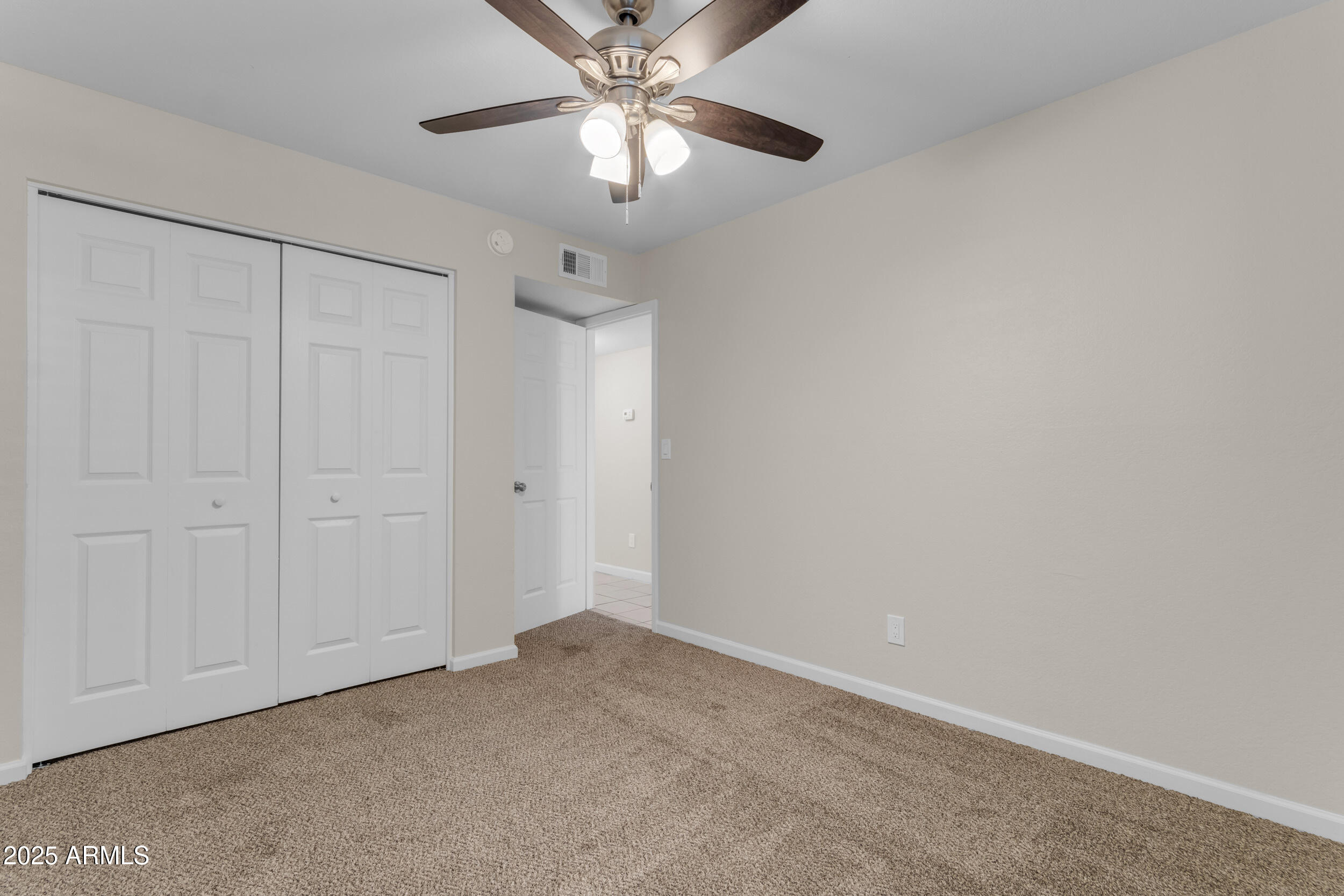 834 North Cherry, Unit 102 Mesa, AZ 85201 - Photo 21 of 24 an empty room with a chandelier fan