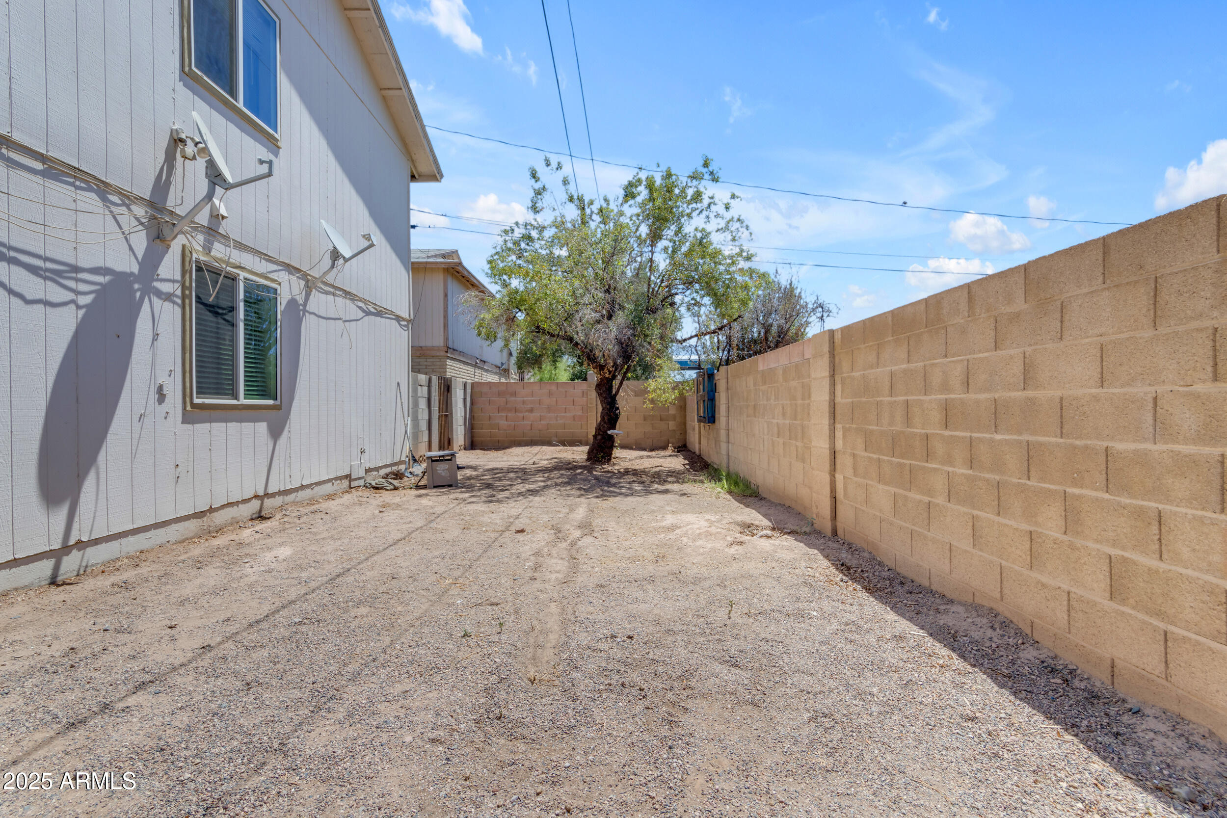 834 North Cherry, Unit 102 Mesa, AZ 85201 - Photo 23 of 24 a view of a house with a yard and garage