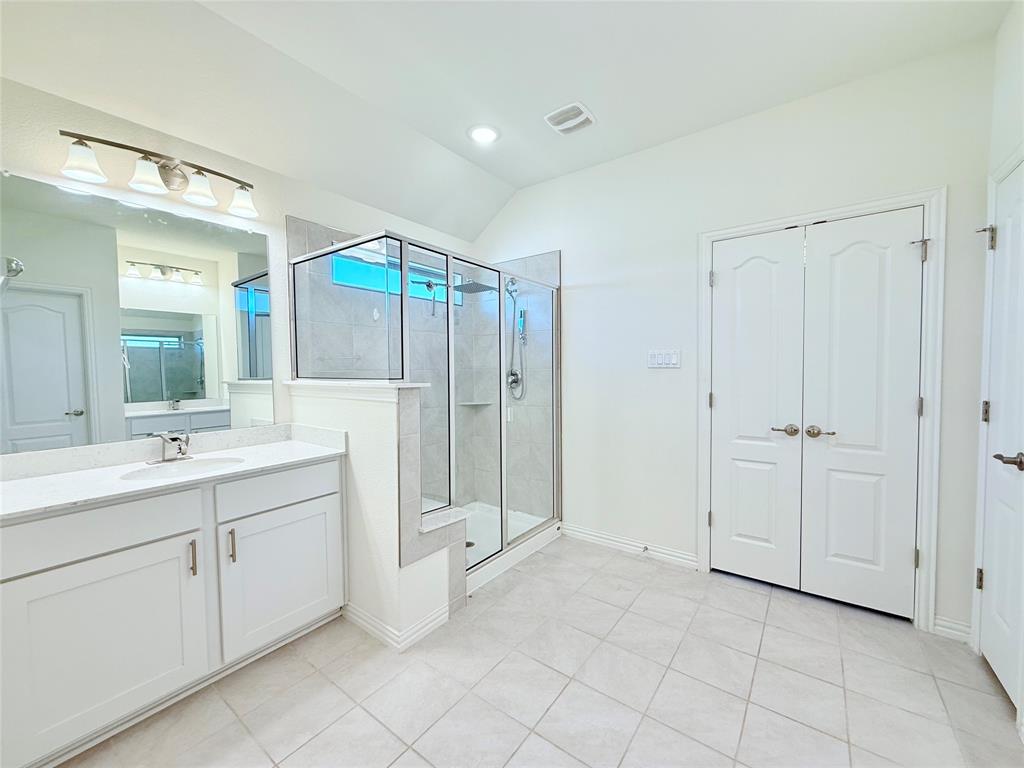 1336 Morning View Road Georgetown, TX 78628 - Photo 20 of 40 A pristine primary bathroom featuring a spacious glass-enclosed shower and a dual-sink vanity.
