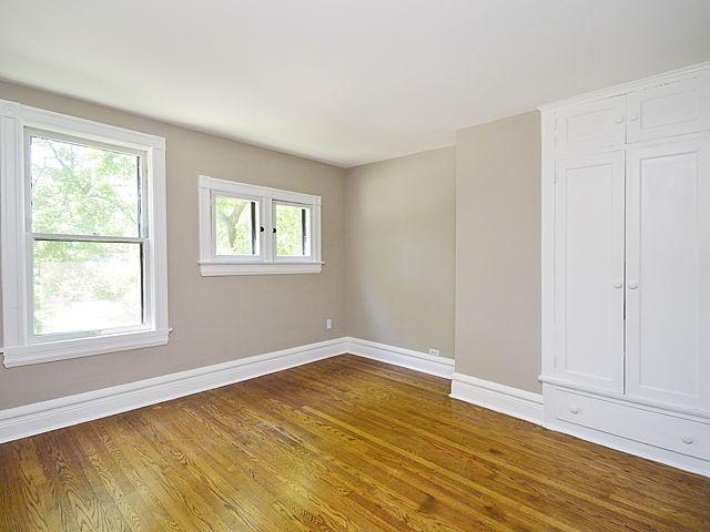 135 Akenside Road Riverside, IL 60546 - Photo 14 of 25 a view of an empty room with wooden floor and a window