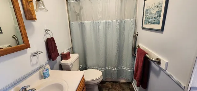 a white toilet sitting next to a bathroom sink