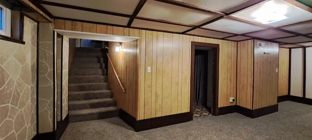 a view of a hallway with wooden walls and entryway