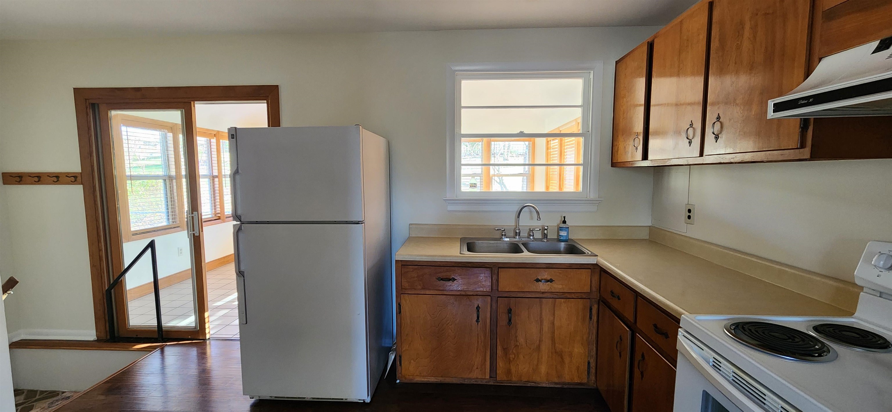 303 Old Greenville Road Staunton, VA 24401 - Photo 7 of 31 a kitchen with a sink a refrigerator and wooden cabinets