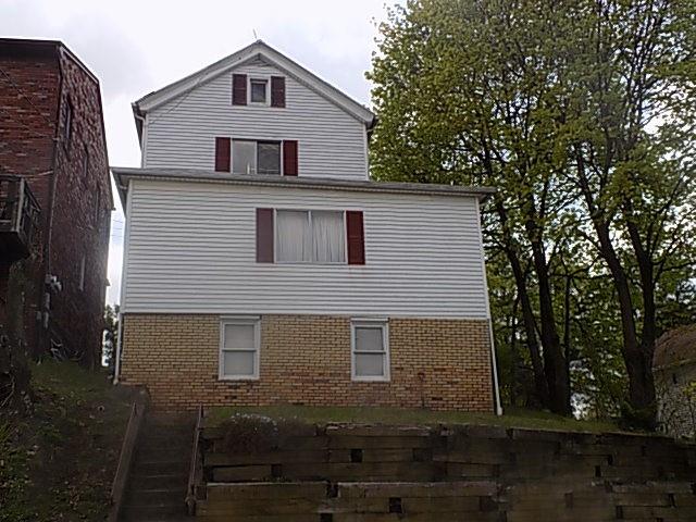 a front view of a house with yard