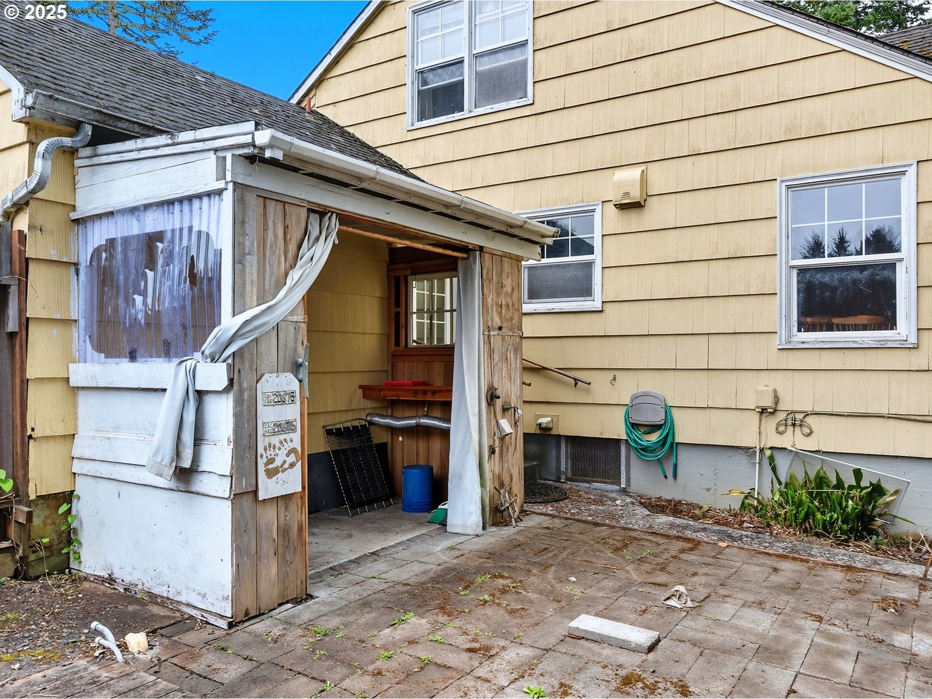 92965 Labeck Road Astoria, OR 97103 - Photo 18 of 31 a backyard of a house with barbeque oven and brick wall