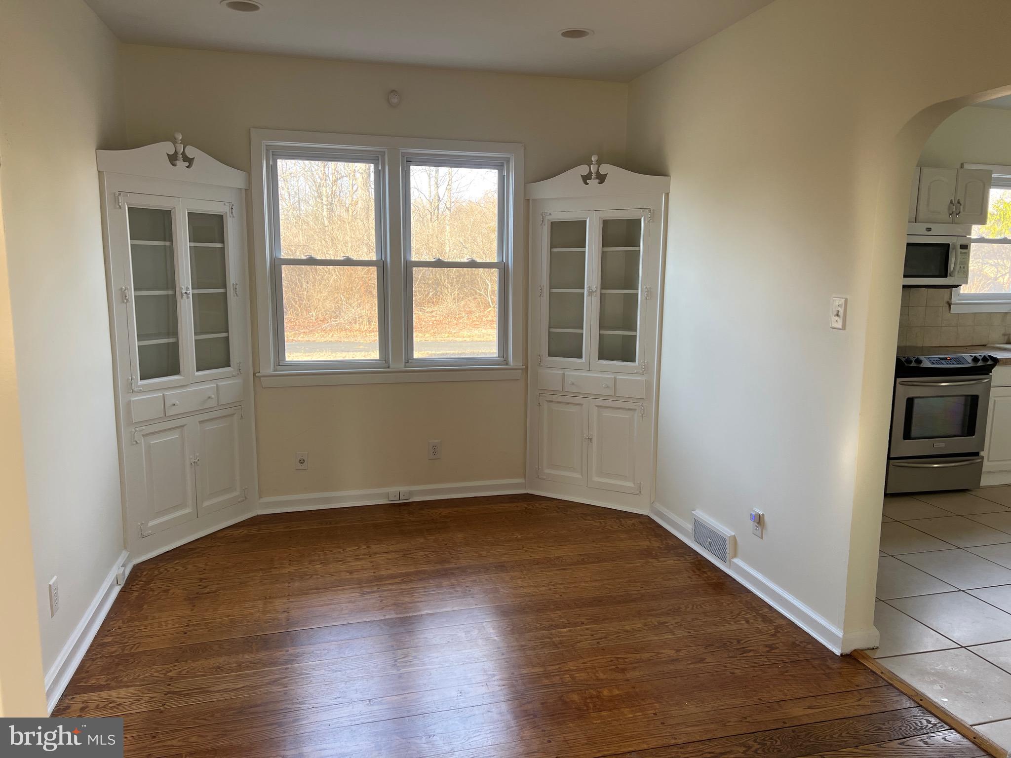 231 Highway 73 Hammonton, NJ 08037 - Photo 11 of 20 an empty room with wooden floor and windows