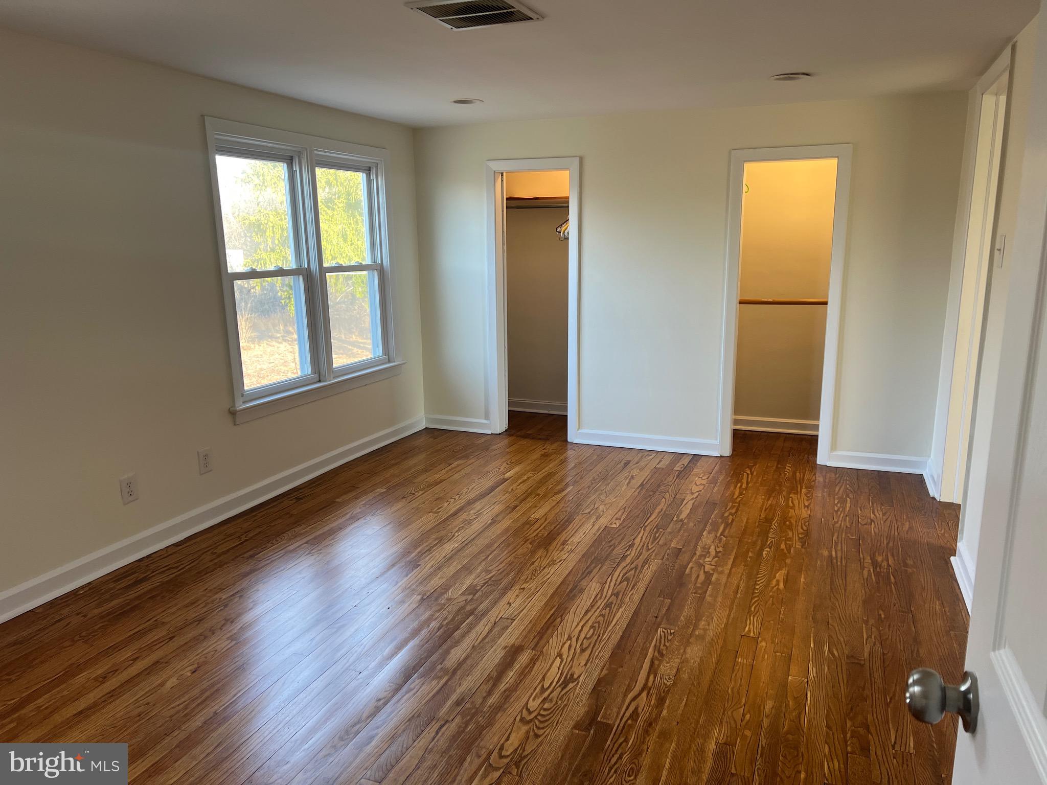 231 Highway 73 Hammonton, NJ 08037 - Photo 14 of 20 an empty room with wooden floor and windows