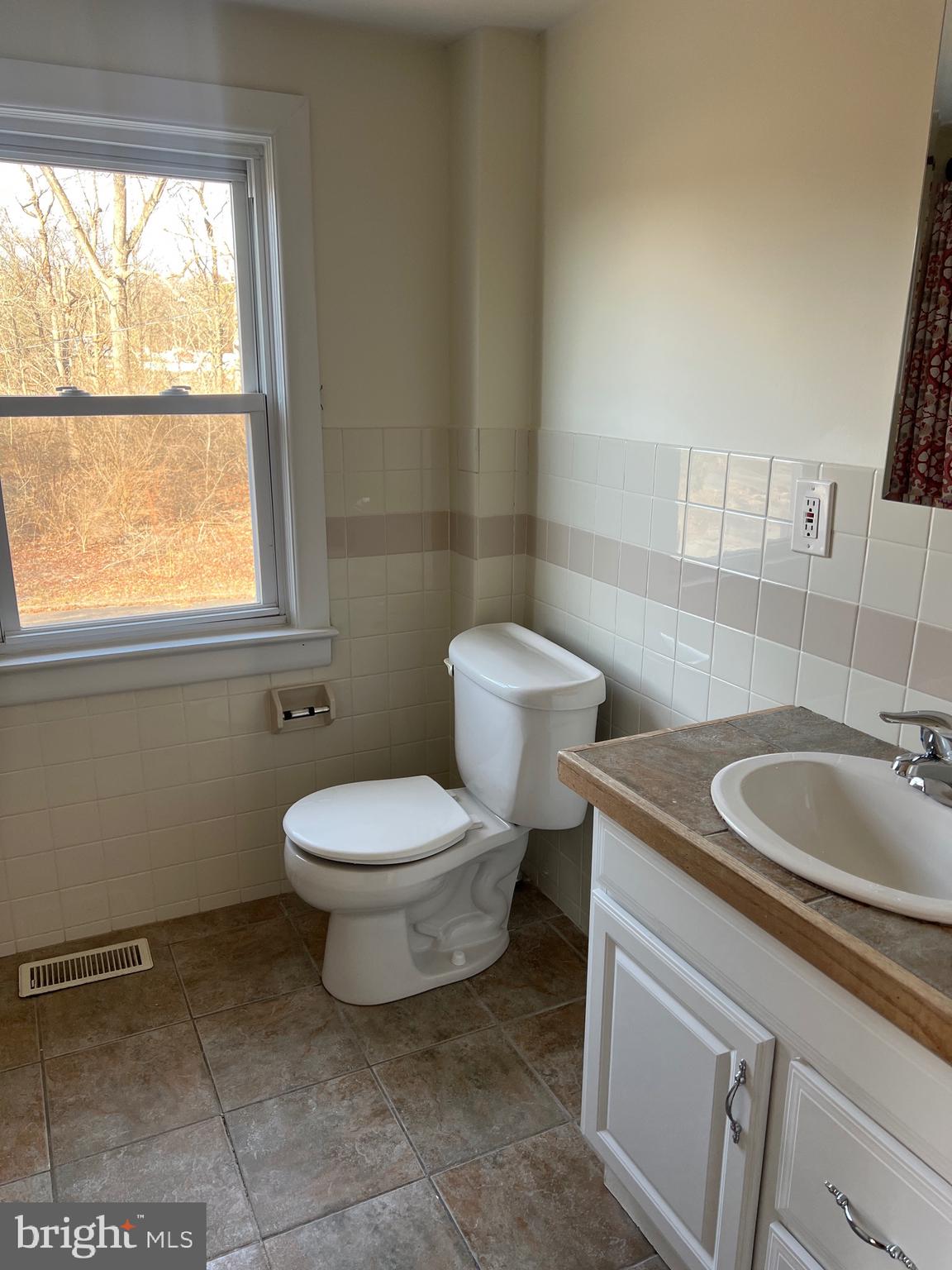 231 Highway 73 Hammonton, NJ 08037 - Photo 15 of 20 a bathroom with a toilet sink and mirror