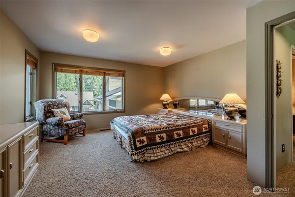 a bed sitting in a room next to a window