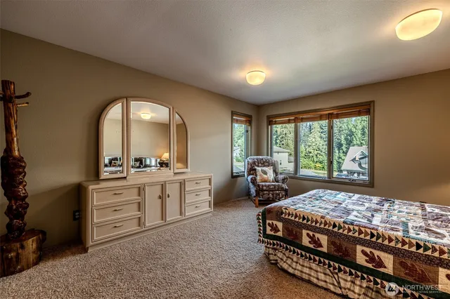 a bedroom with a bed and a large window