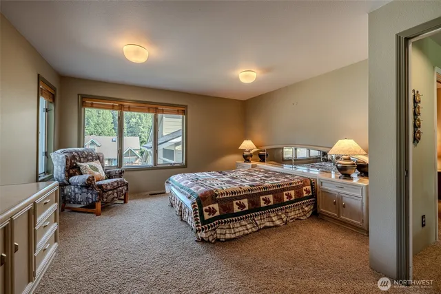 a bed sitting in a room next to a window