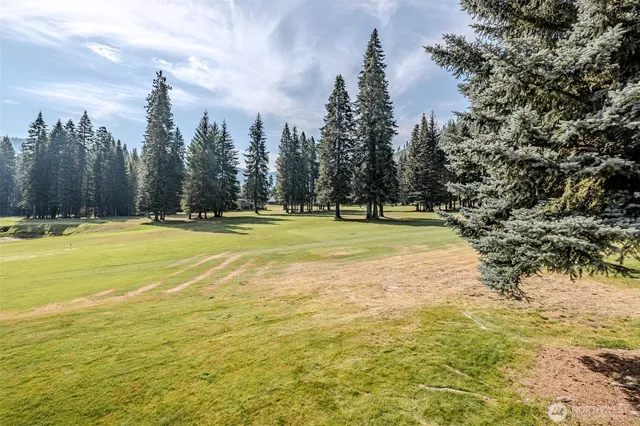 a view of a swimming pool with an outdoor space and seating area