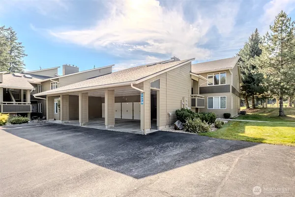 a front view of a house with swimming pool and porch