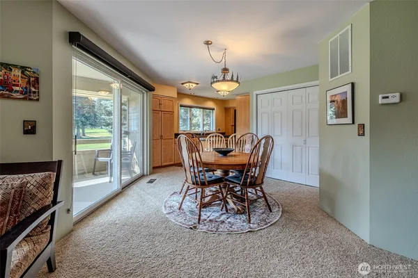 a view of a dining room with furniture window and outside view